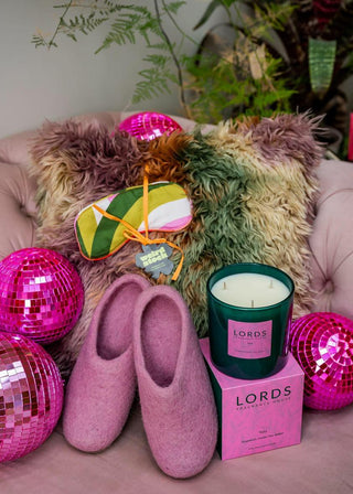 Pink Cosy Buddha Slippers, LORDS Yala candle, Weirdsock Ventura cushion and Weirdstock Groove Inn Sleep mask