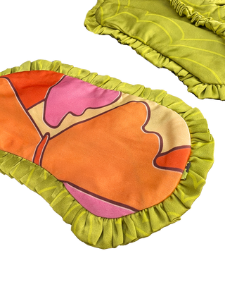 Colourful decorative silk eye mask with abstract design on a white background