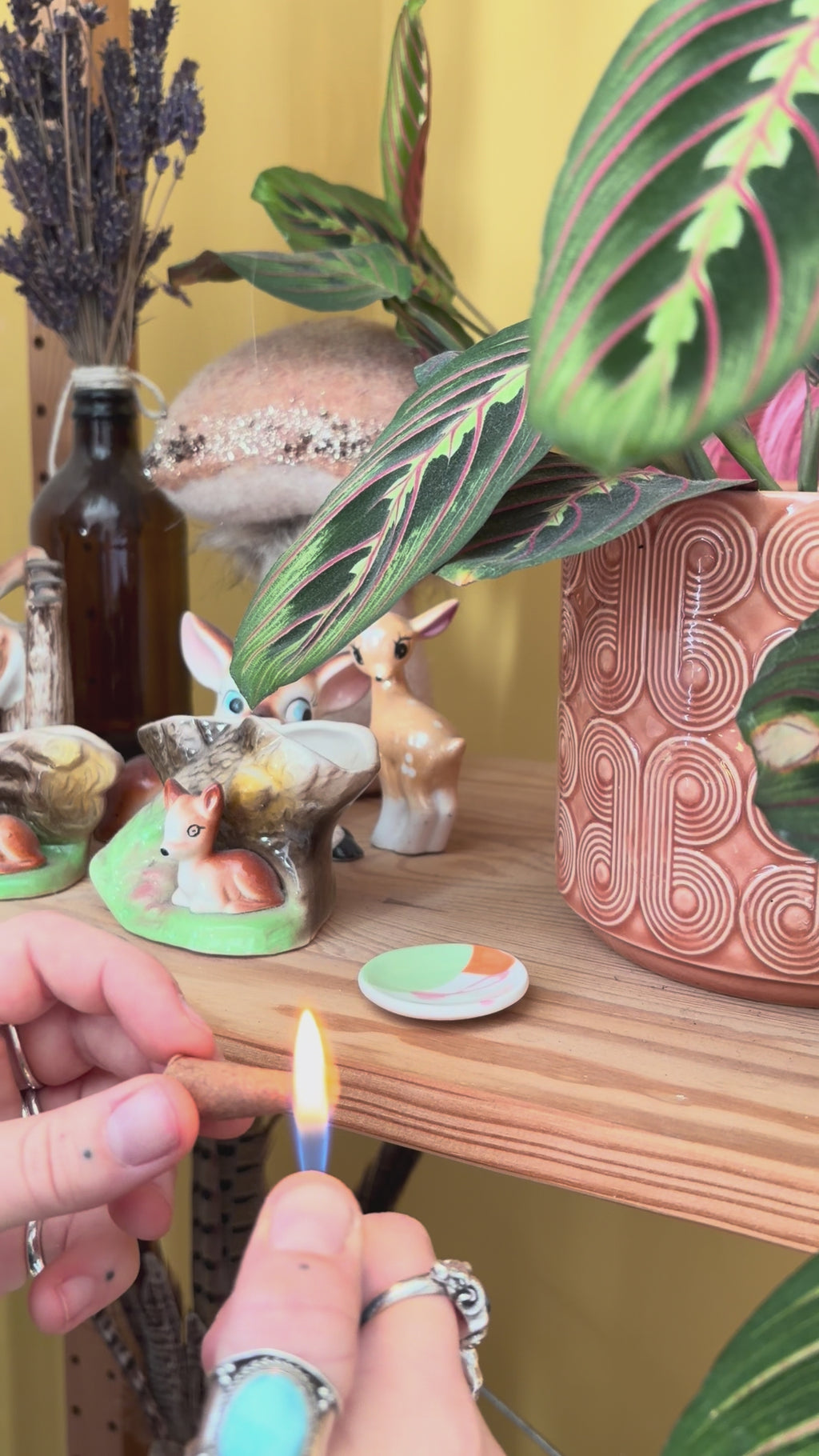 Incense cone is lit and placed on small colourful porcelain holder