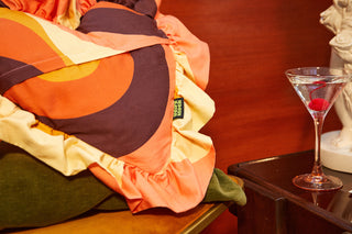 Closeup shot of 70s colourful retro printed organic cotton ruffle cushion from Weirdstock